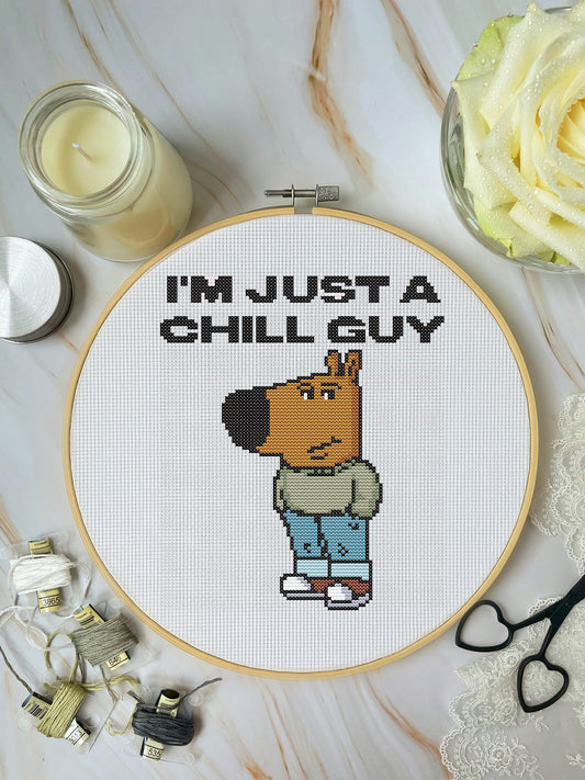 Cross-stitched design of a cartoon character with 'I'm just a chill guy' text on a marble surface.