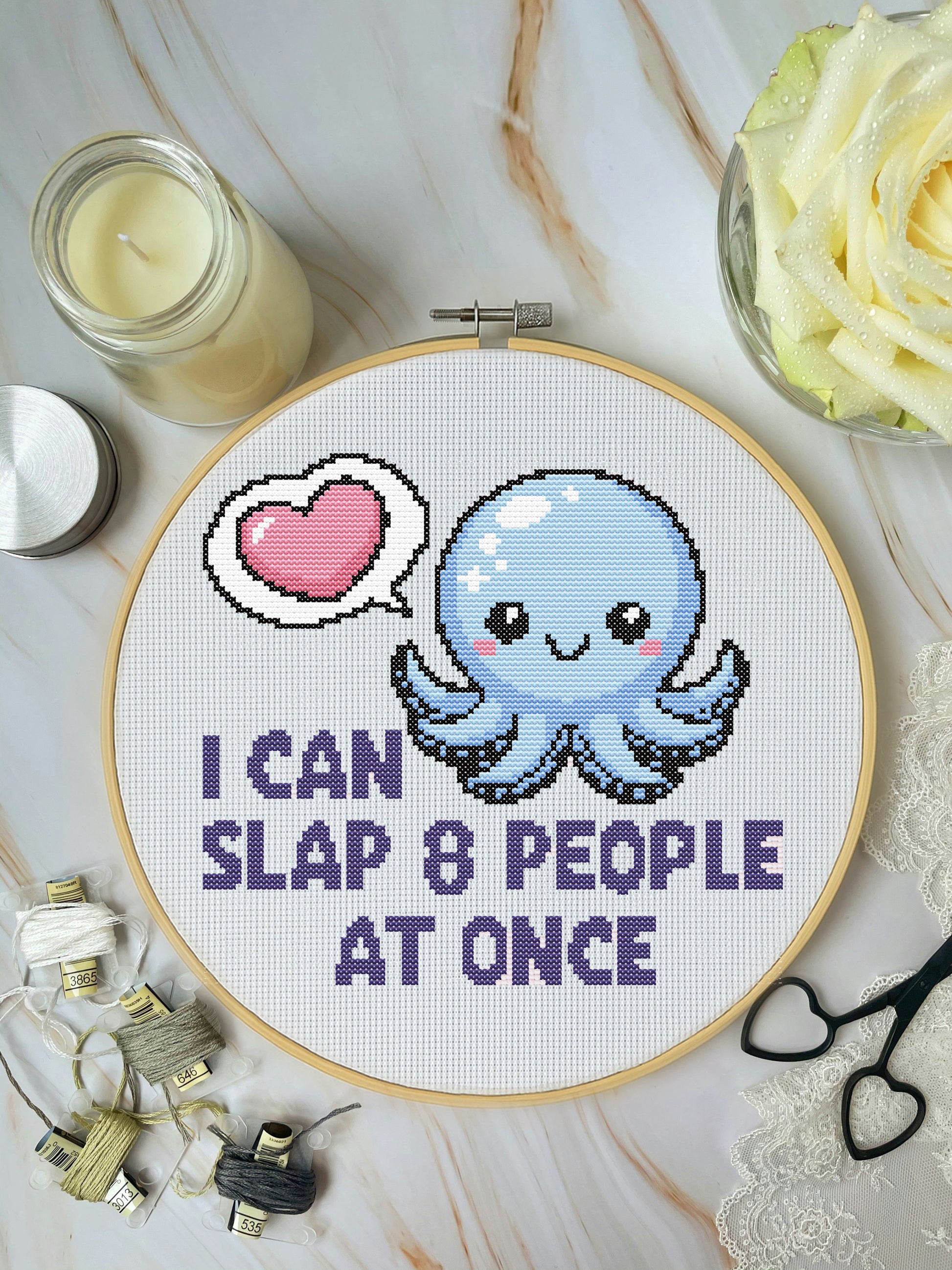 Cross-stitched octopus with text 'I can slap 8 people at once' on a white background.
