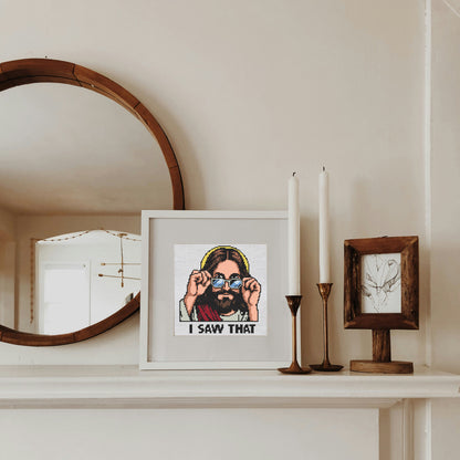 Framed artwork on a mantelpiece with candles and a mirror.