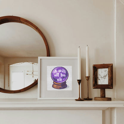 Framed artwork with motivational quote on a shelf next to candles and a mirror.