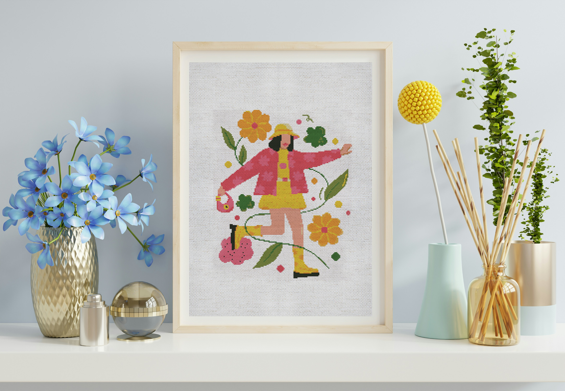 Framed artwork of a person in a pink coat with flowers on a light blue wall.
