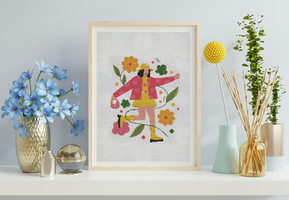 Framed artwork of a person in a pink coat with flowers on a light blue wall.
