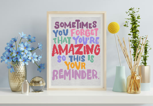 Framed motivational poster with colorful text in a home setting with decor items.