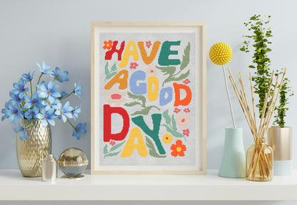 Framed colorful artwork with 'Have a Good Day' text on a shelf with decorative items.