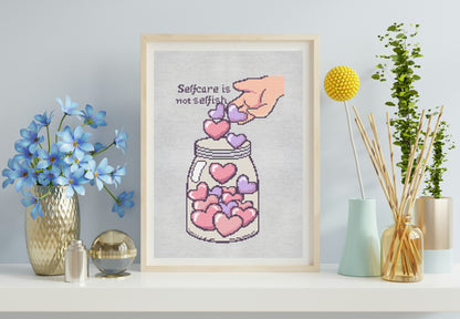 Framed cross-stitch art of a mason jar with hearts and a quote on a wall with decorative items.