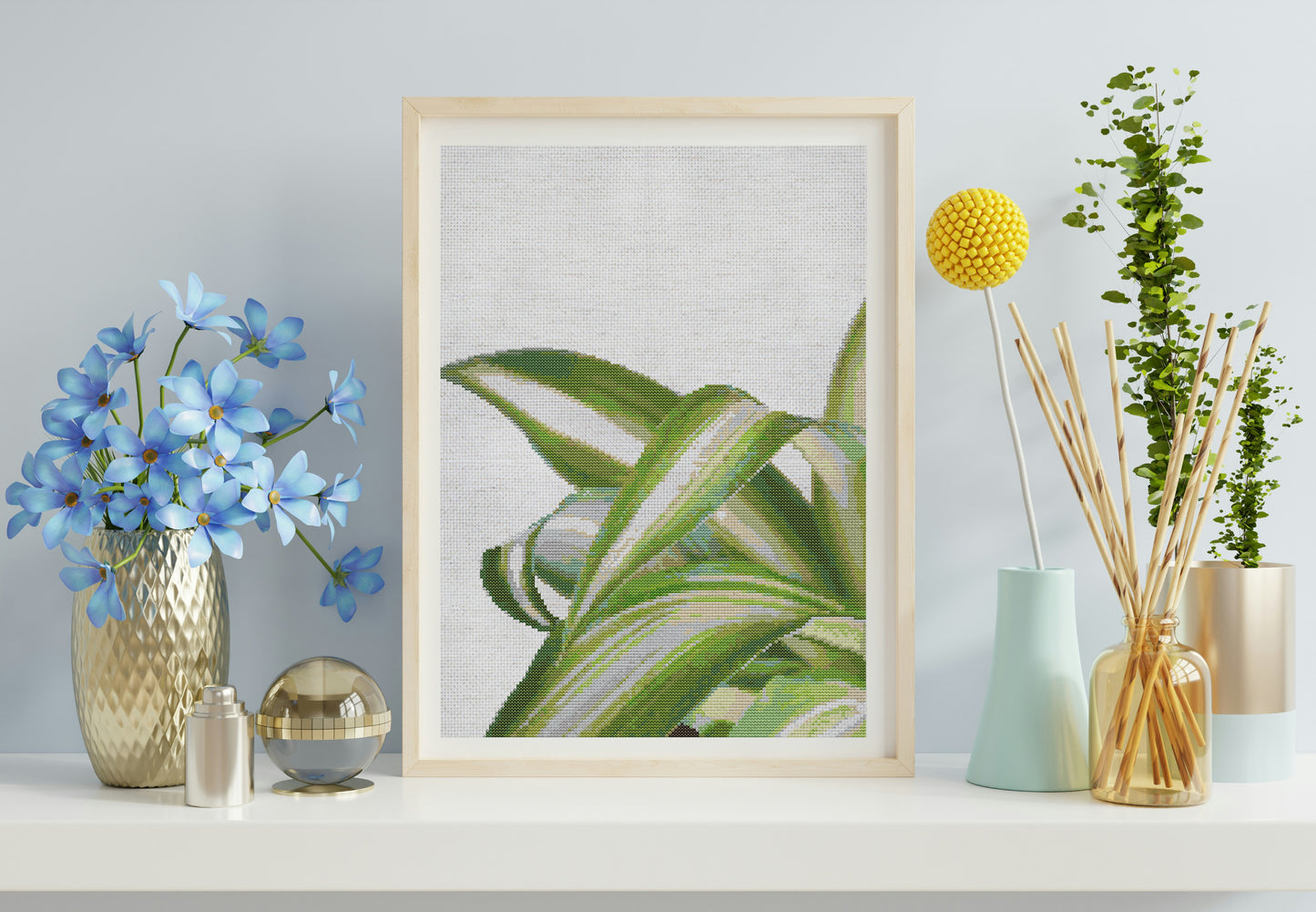 Framed plant print on a shelf with decorative items