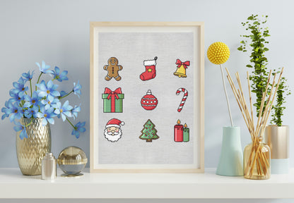 Framed cross-stitch art with Christmas-themed designs on a shelf with decorative items.