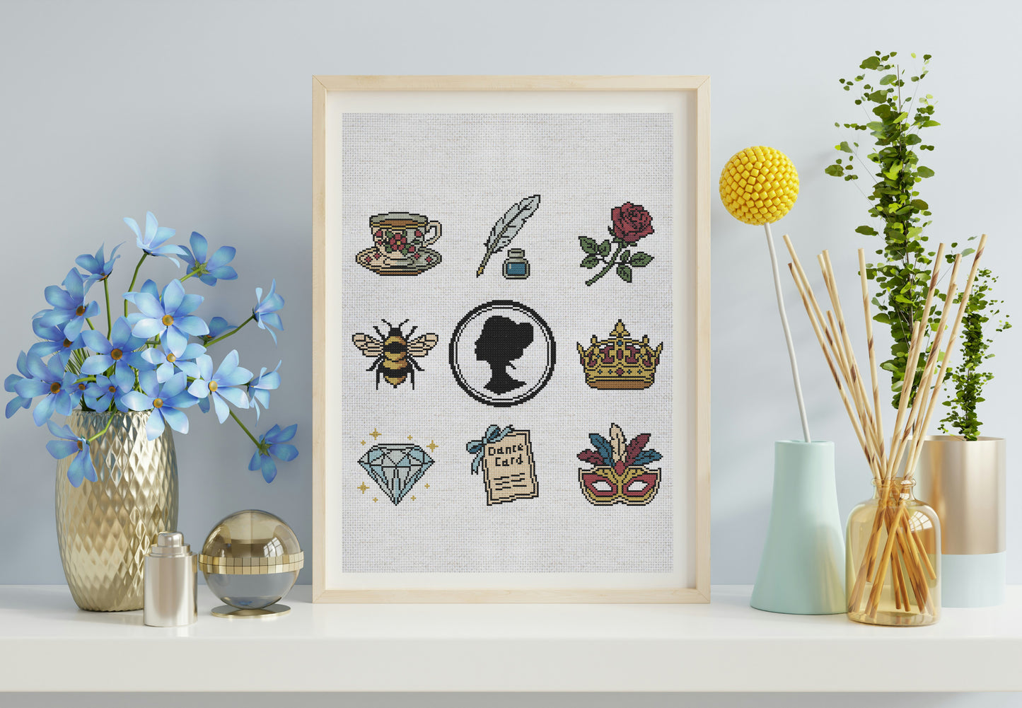 Framed artwork with various decorative elements on a shelf with decorative items.