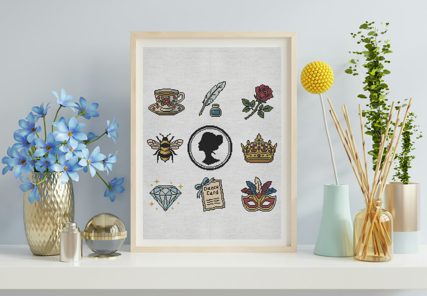 Framed artwork with various decorative elements on a shelf with decorative items.