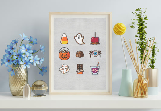 Framed artwork with colorful Halloween-themed stickers on a light gray wall.