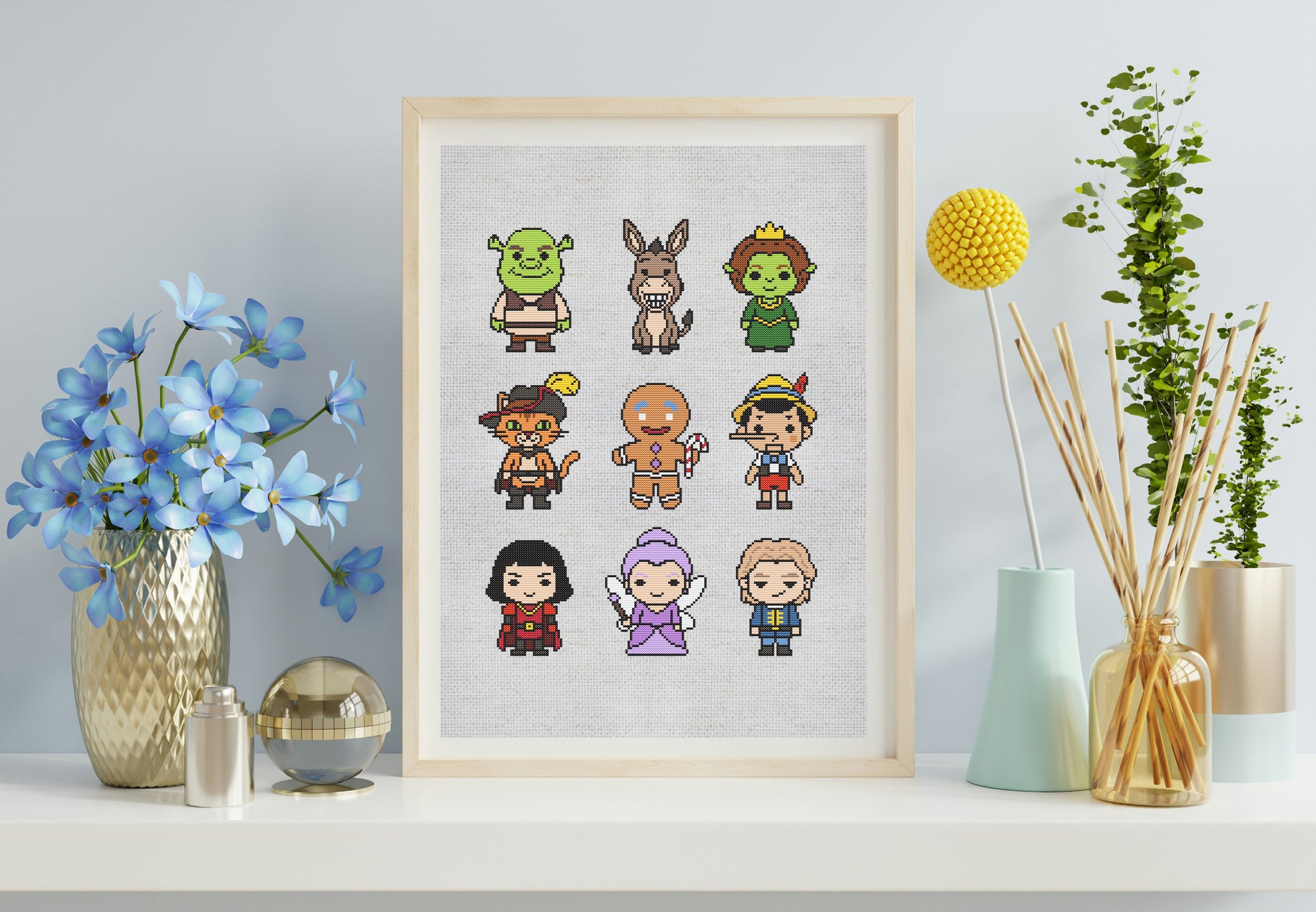 Framed artwork with pixel art characters on a shelf with decorative items.