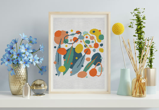 Framed abstract artwork with colorful flowers on a shelf with decorative items.