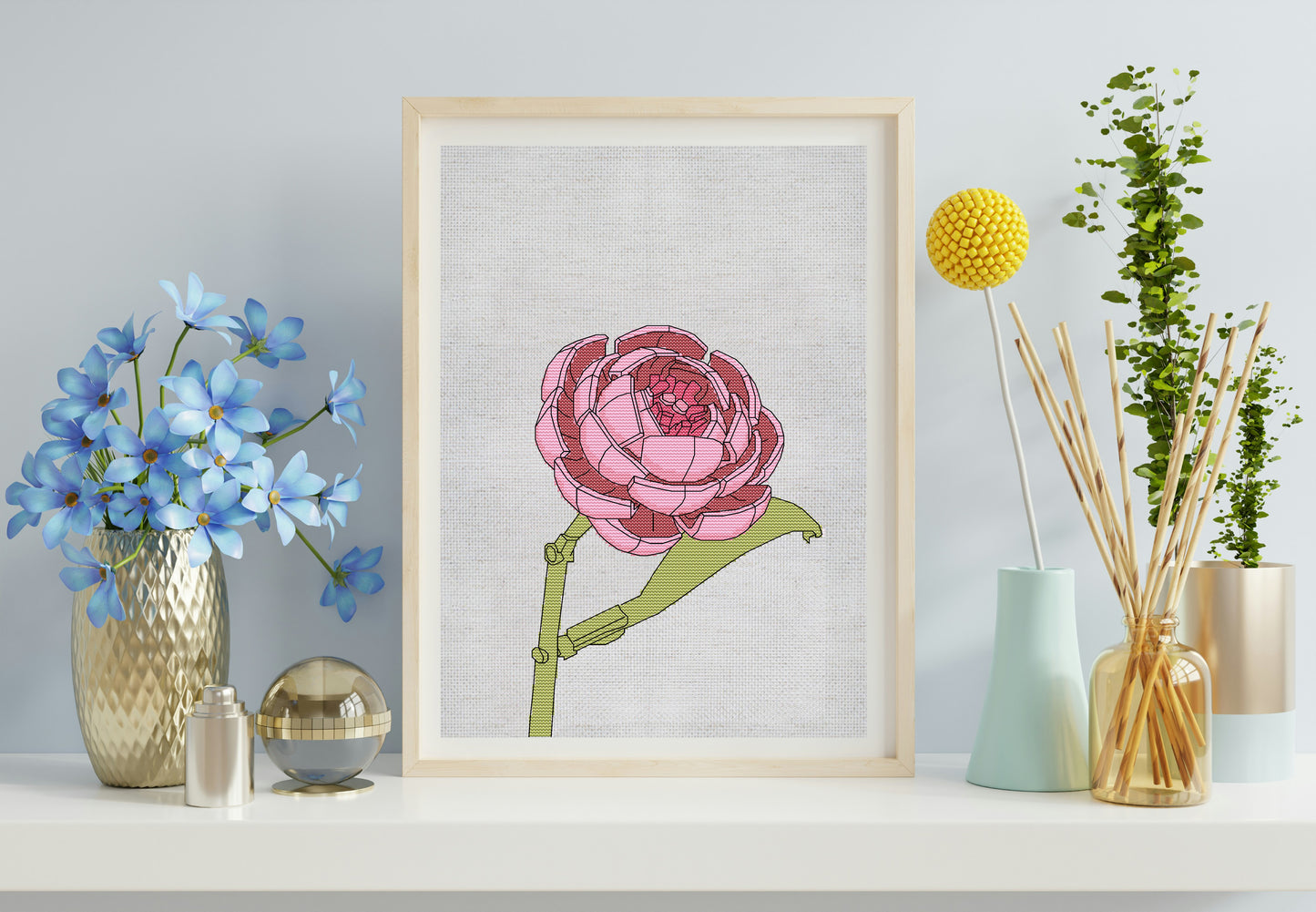 Framed floral artwork on a shelf with decorative items
