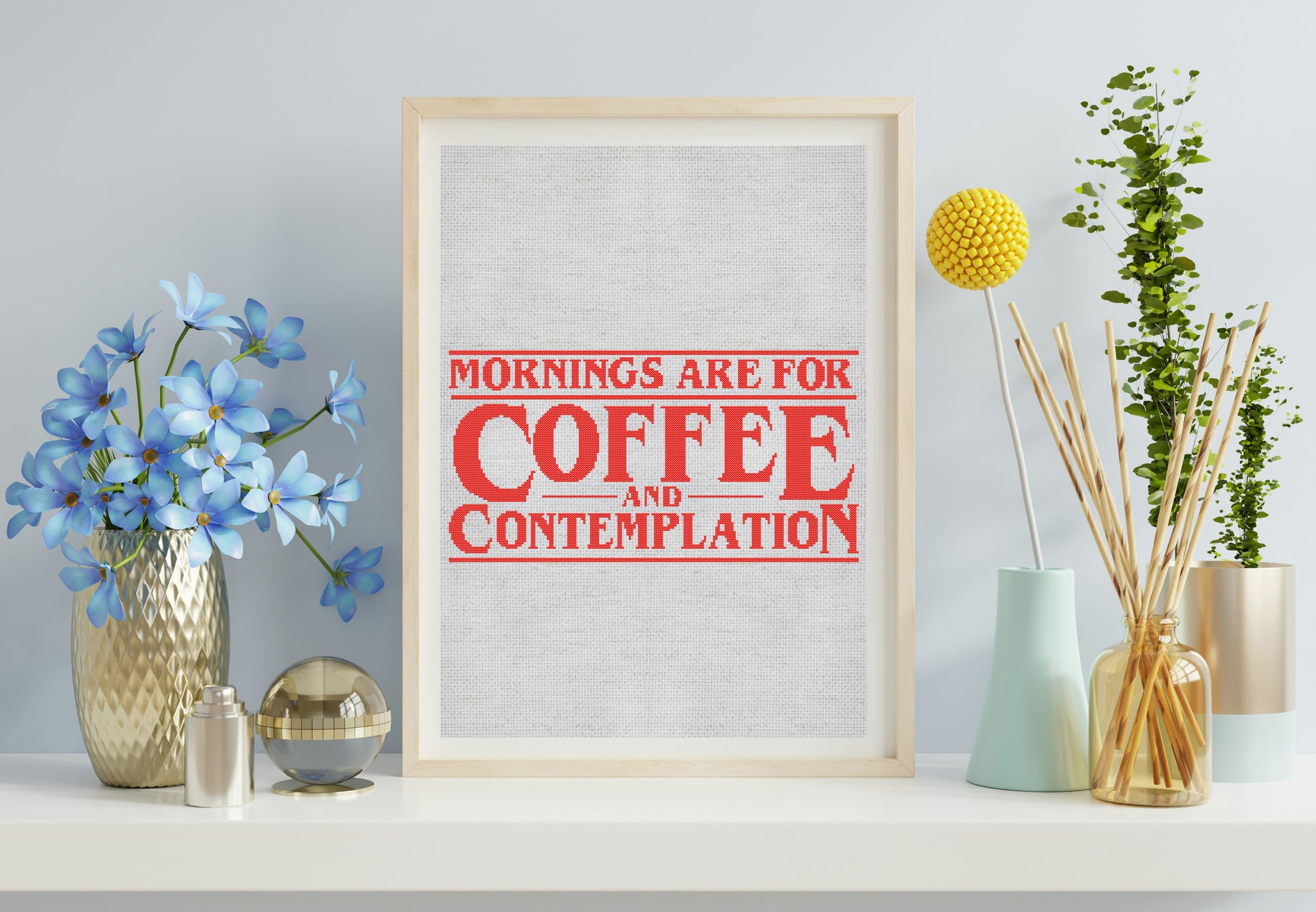 Framed print with 'Mornings are for Coffee and Contemplation' text on a wall with decorative items.