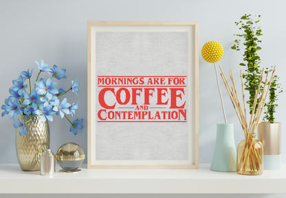 Framed print with 'Mornings are for Coffee and Contemplation' text on a wall with decorative items.