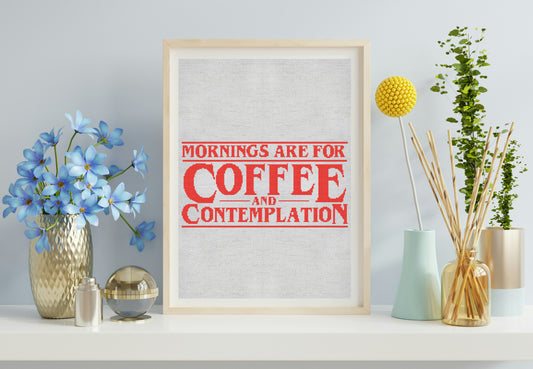 Framed print with 'Mornings are for Coffee and Contemplation' text on a wall with decorative items.