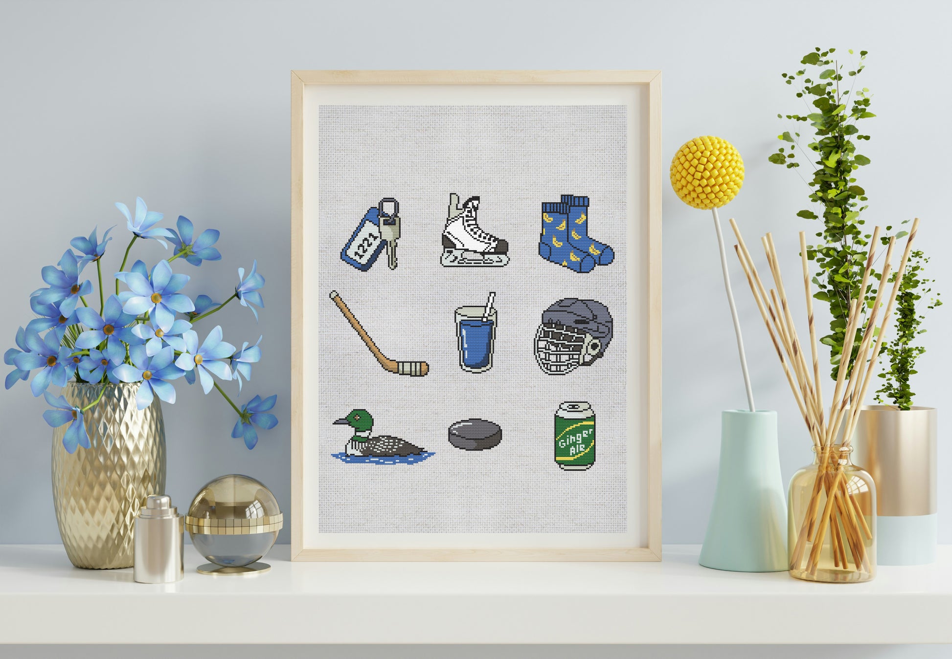 Framed artwork with hockey-themed illustrations on a shelf with decorative items.