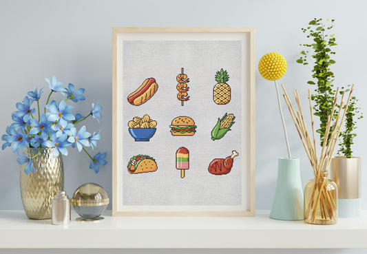 Framed artwork with colorful illustrations of food items on a light gray wall.