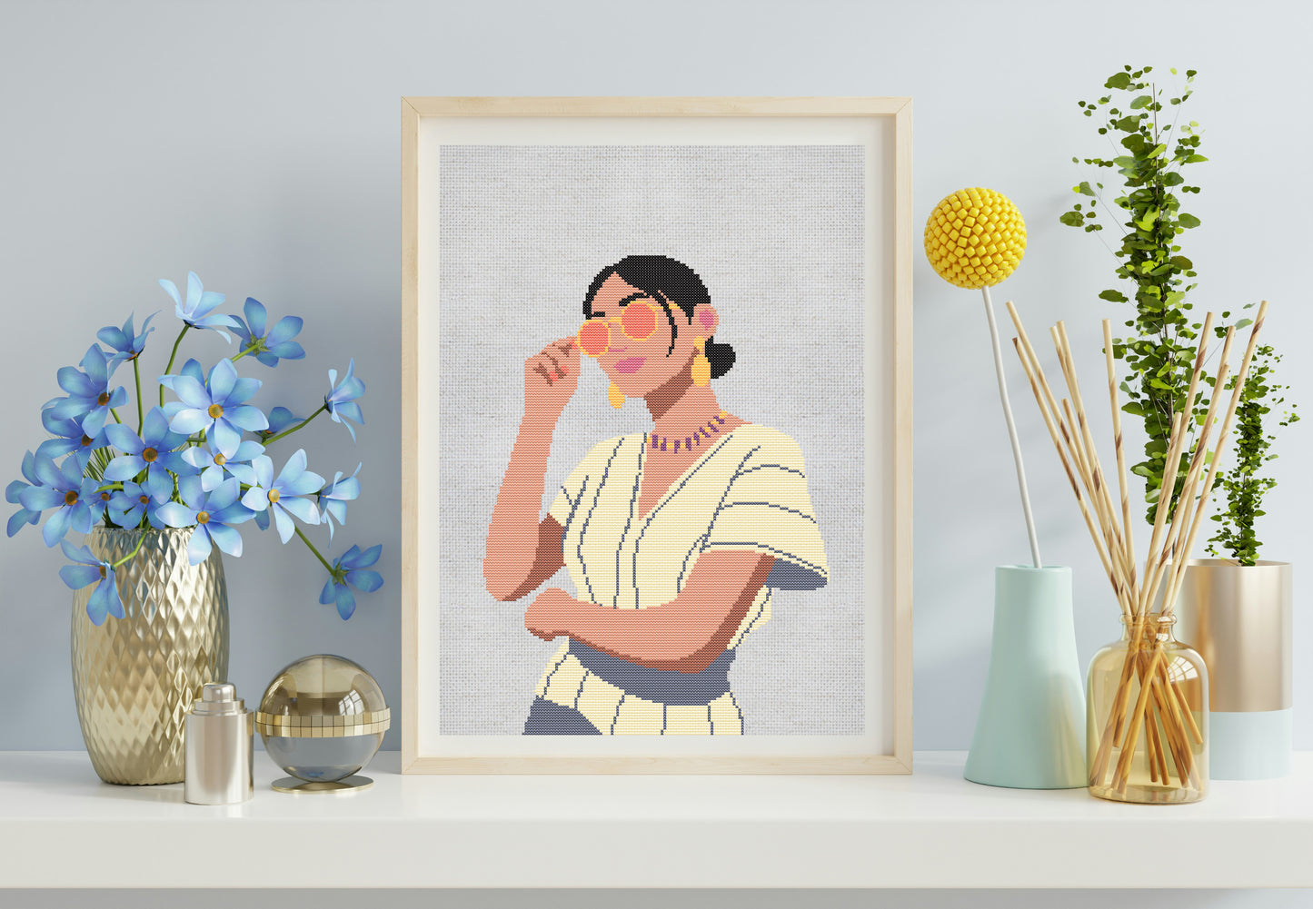 Framed artwork of a woman with flowers and decorative items on a shelf.