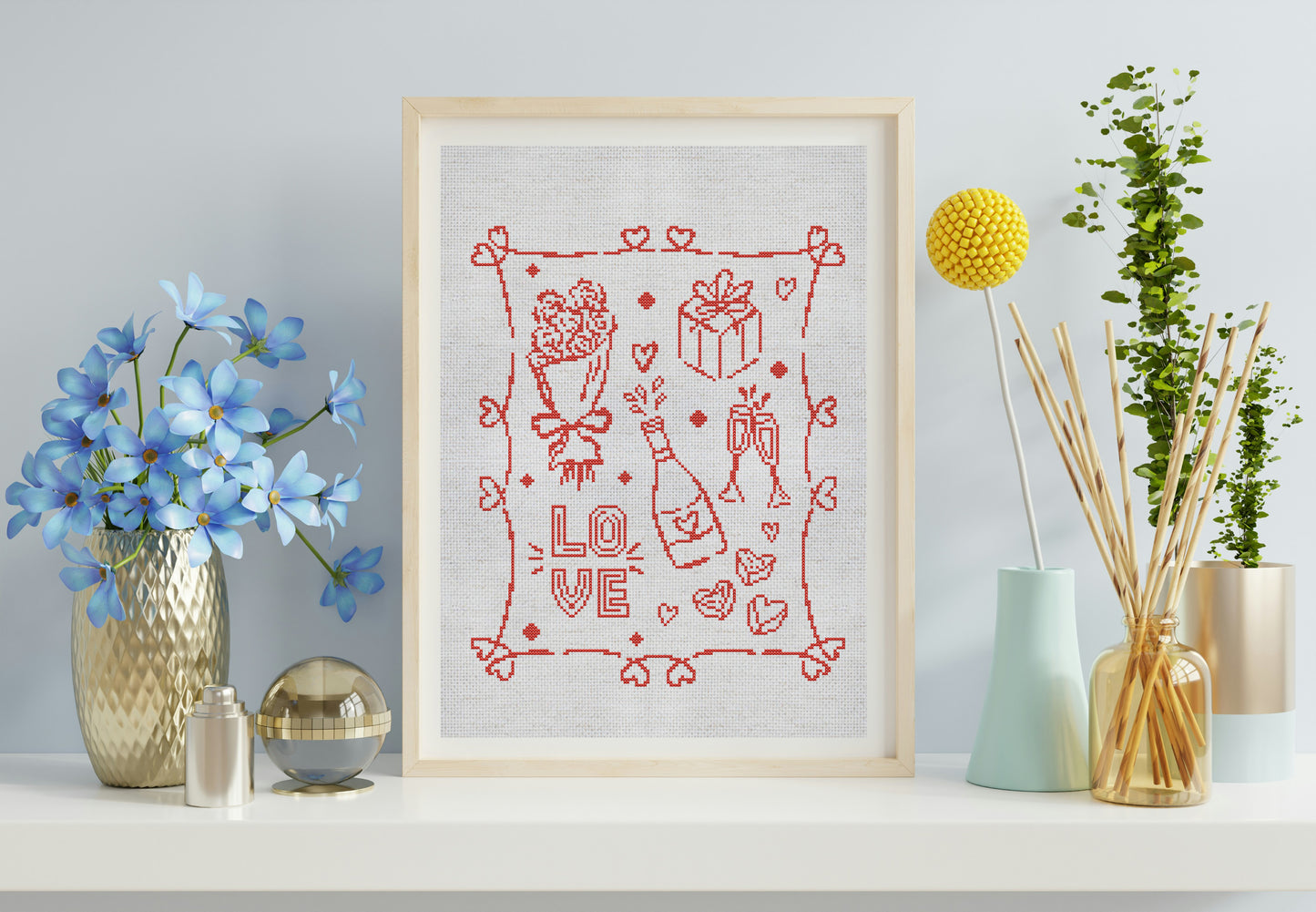 Framed artwork with red 'LOVE' design on a white background, surrounded by decorative items.