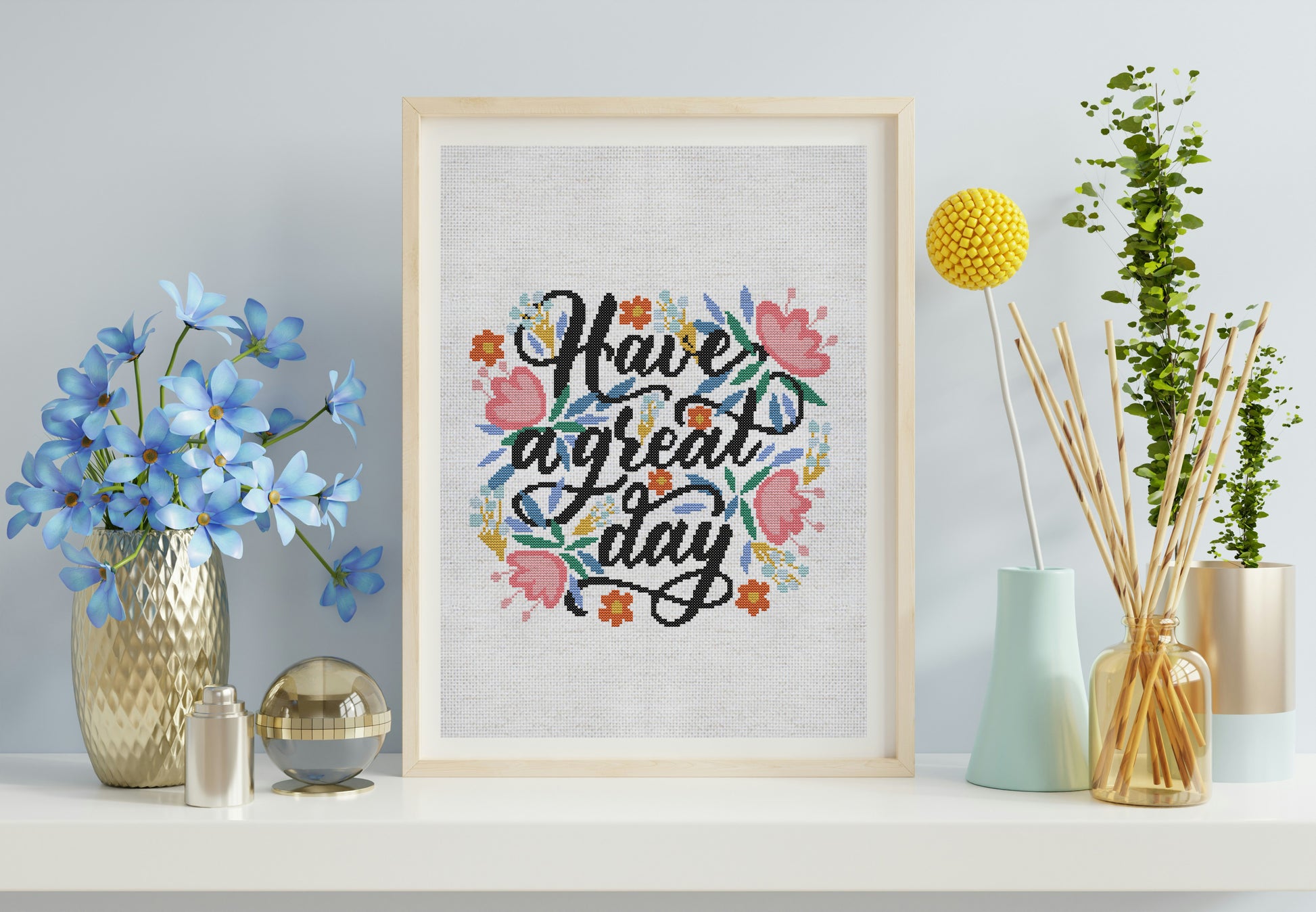 Decorative wall art with floral text design on a shelf with decorative items.