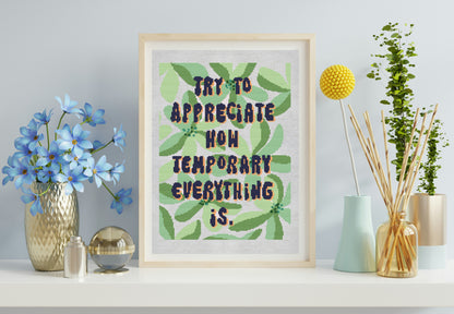 Framed artwork with motivational quote on a shelf with decorative items