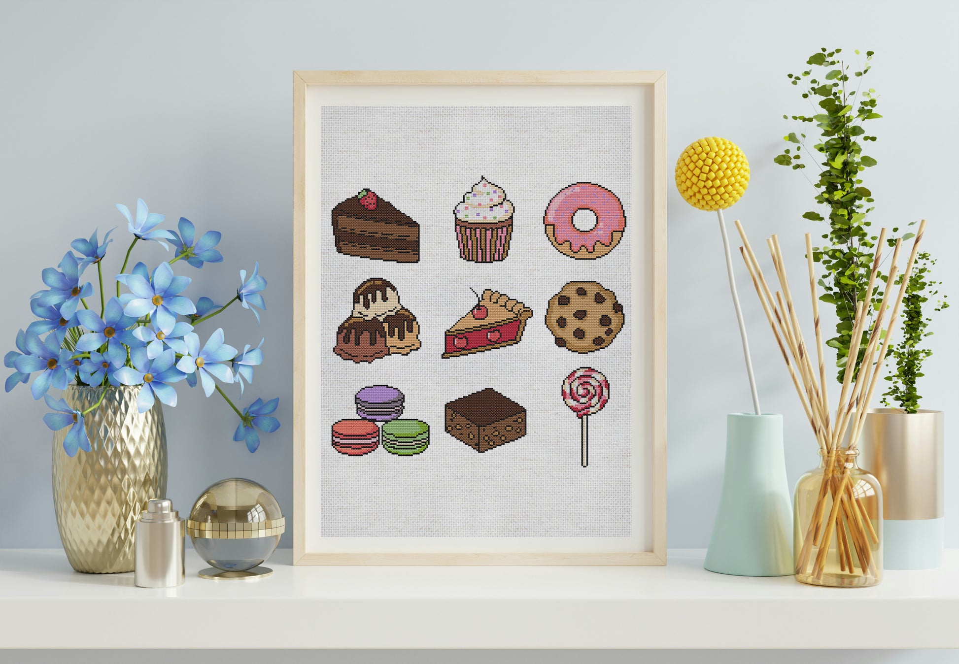 Framed artwork of various desserts on a white wall with decorative items.