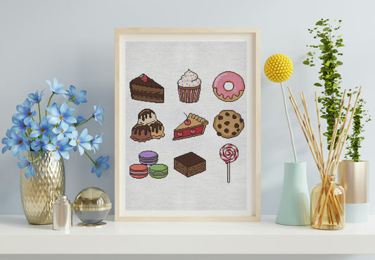 Framed artwork of various desserts on a white wall with decorative items.