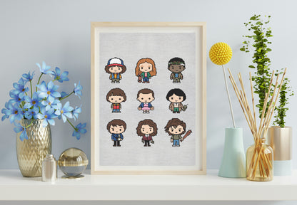 Framed cross-stitch art of cartoon characters on a wall with decorative items.
