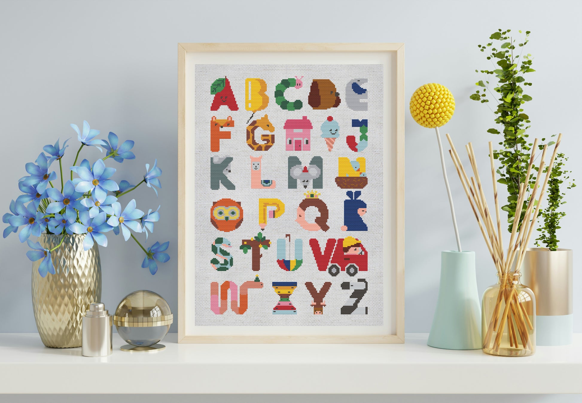 Framed alphabet poster on a shelf with decorative items