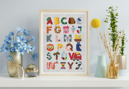 Framed alphabet poster on a shelf with decorative items