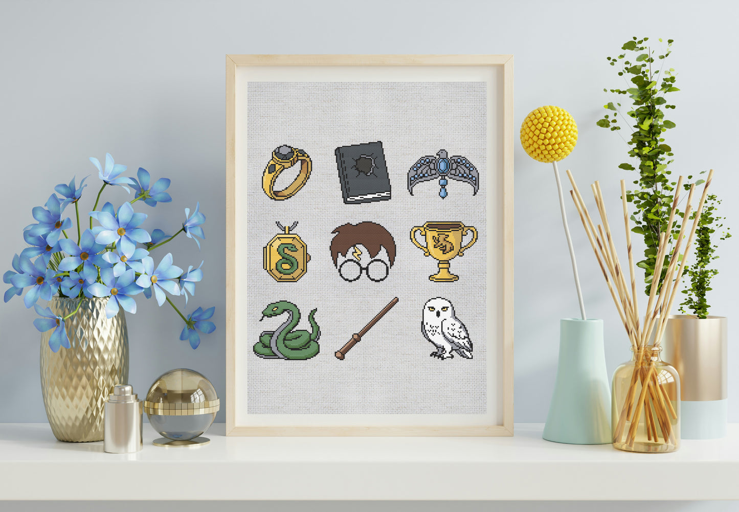 Framed artwork with Harry Potter-themed icons on a shelf with decorative items.