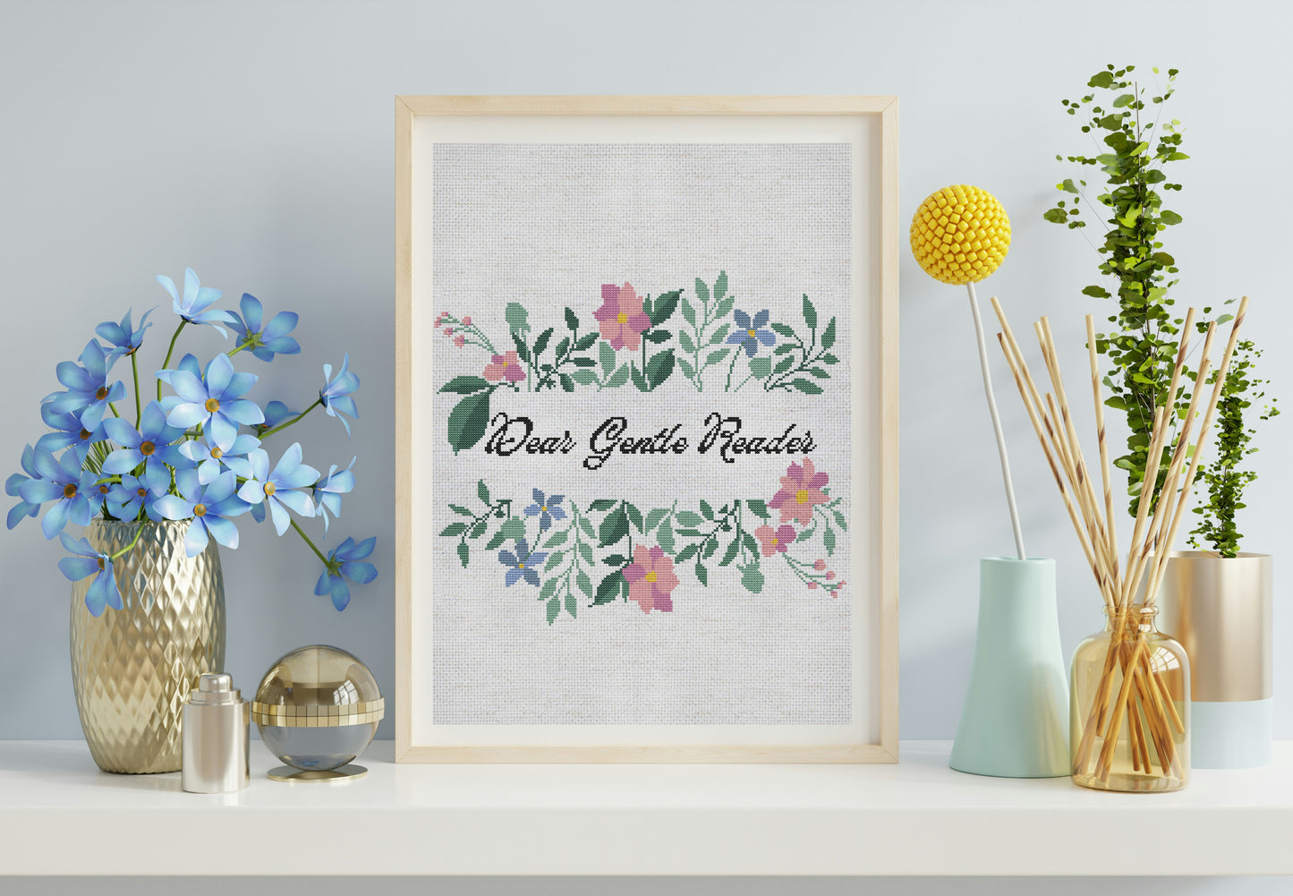 Framed artwork with floral design and text on a shelf with decorative items.