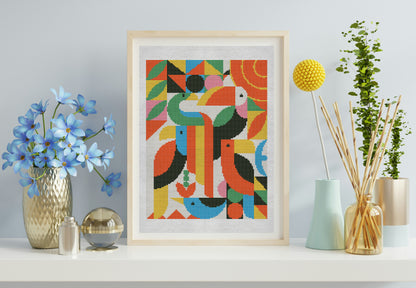 Framed abstract art print of colorful birds on a wall with decorative items.