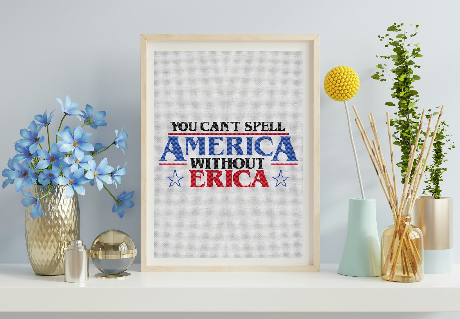 Framed print with 'You can't spell America without Erica' text on a shelf with decorative items.