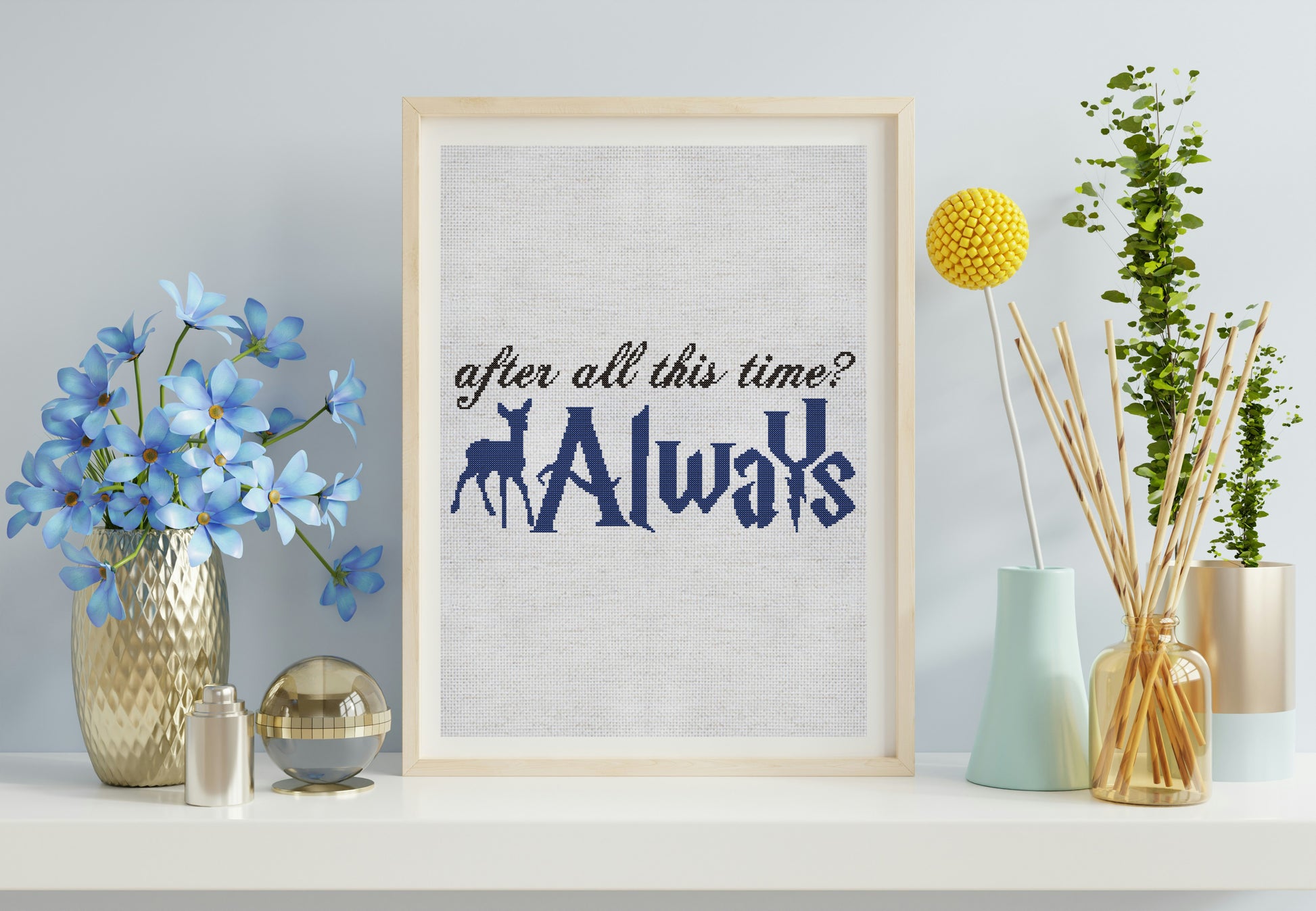 Framed print with 'After all this time? Always' text on a shelf with decorative items.