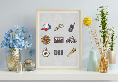 Framed artwork with various icons on a wall with decorative items.