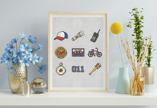 Framed artwork with various icons on a wall with decorative items.