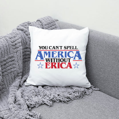 White pillow with text 'You can't spell America without Erica' on a gray couch.