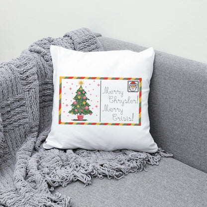 Decorative pillow with Christmas tree design and text on a gray couch.