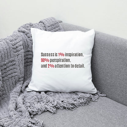 White pillow with motivational quote on a gray couch with a textured blanket.