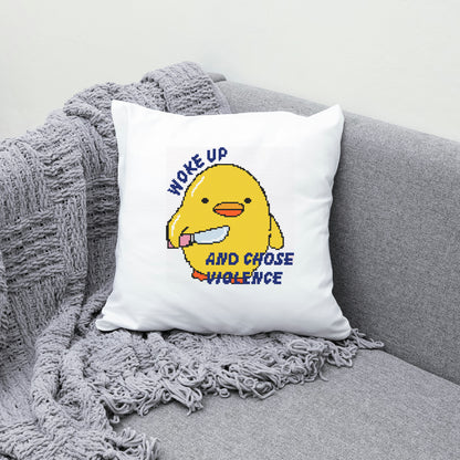 White pillow with a yellow character and text on a gray couch