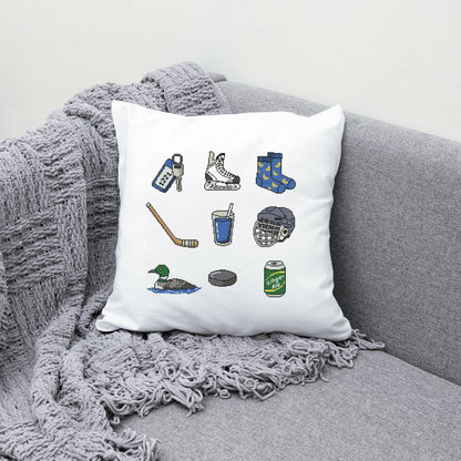 Decorative pillow with hockey-themed illustrations on a gray couch.