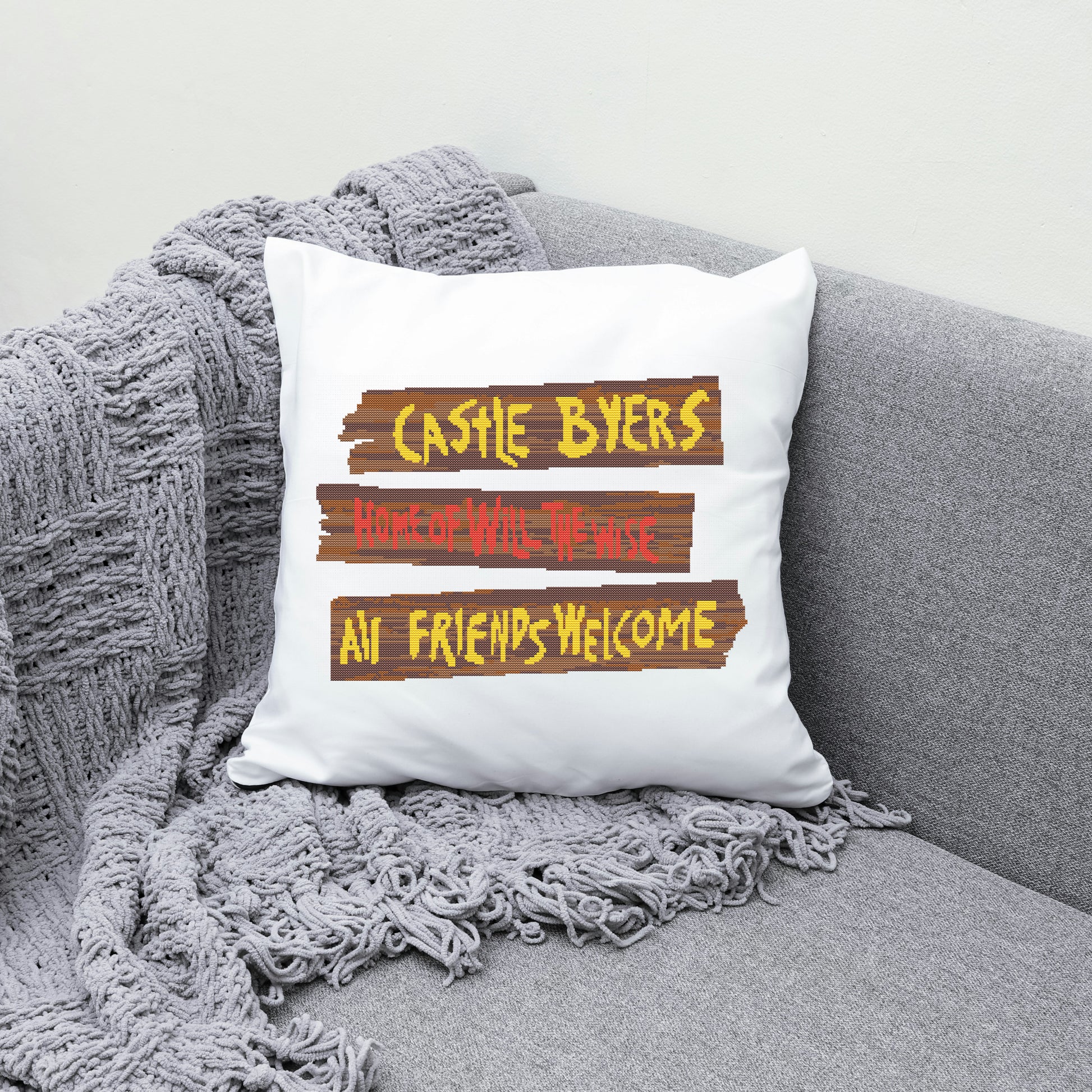 White pillow with text on a gray couch