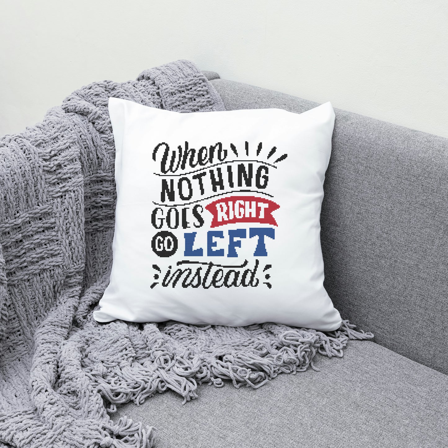 White pillow with humorous text on a gray couch
