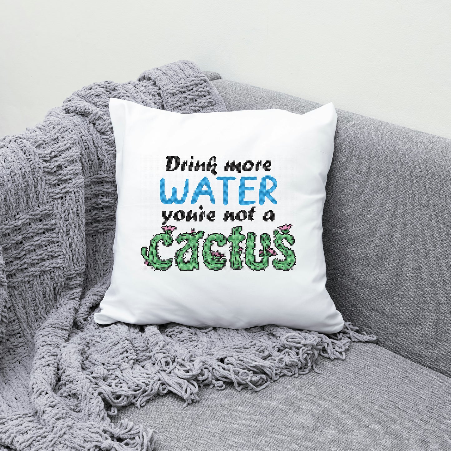 White pillow with humorous text on a gray couch
