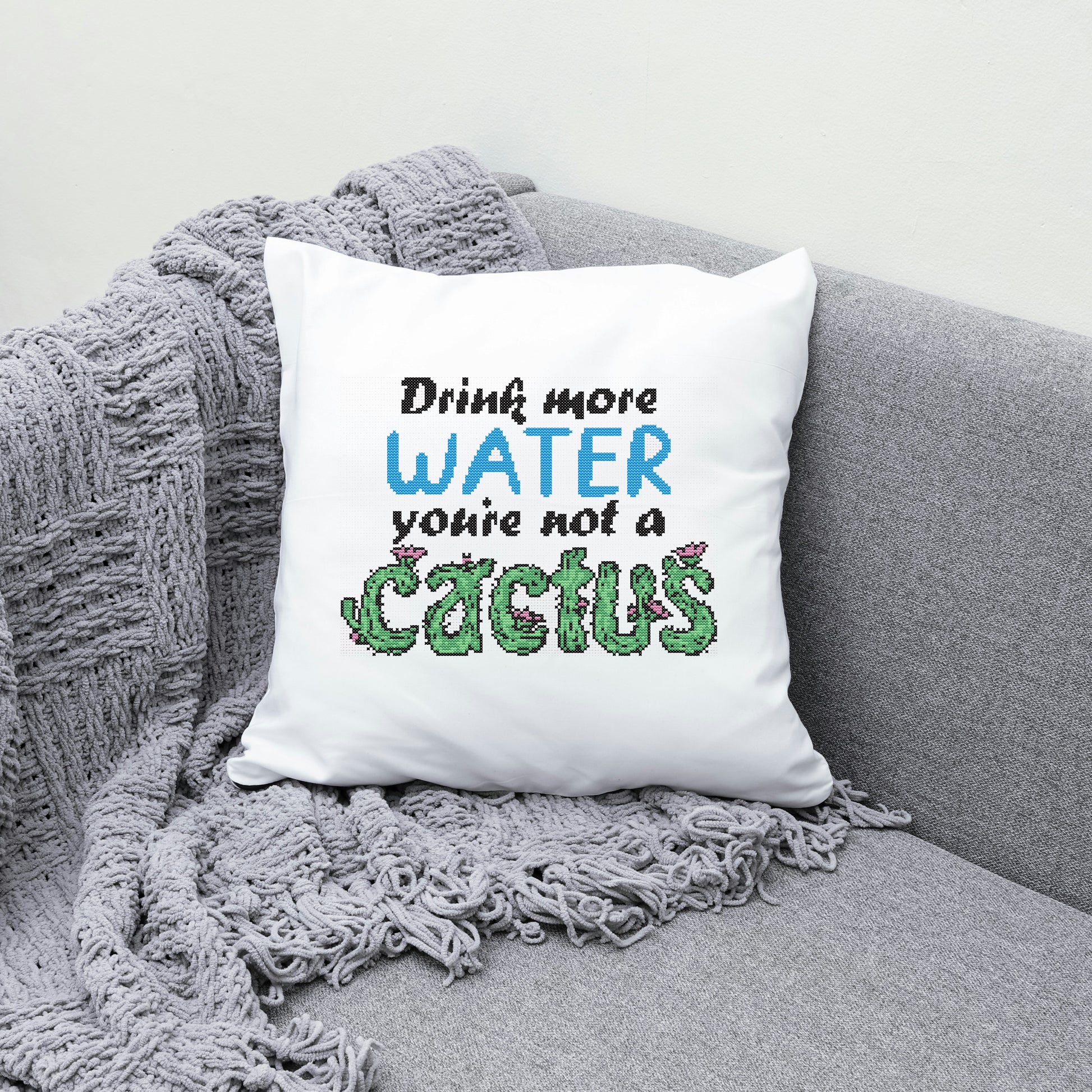 White pillow with humorous text on a gray couch