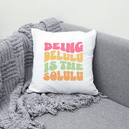 White pillow with colorful text on a gray couch