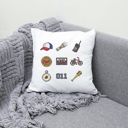 Decorative pillow with embroidered icons on a gray couch