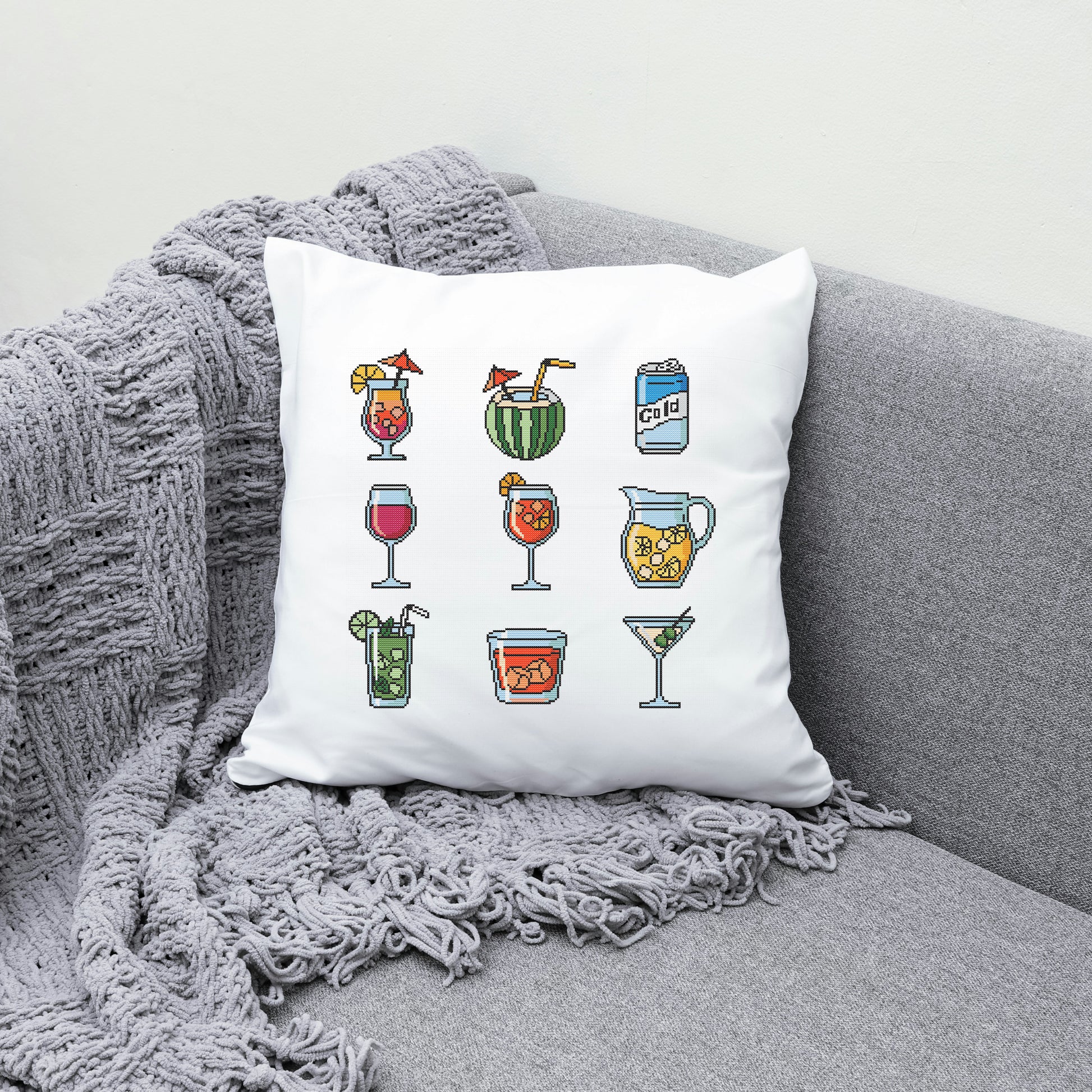 Decorative pillow with drink illustrations on a gray couch
